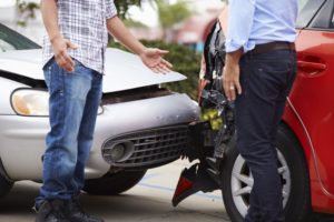 two men in front of car accident