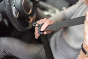 man putting on seatbelt