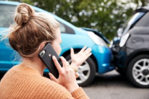 woman talking on the phone after a car accident