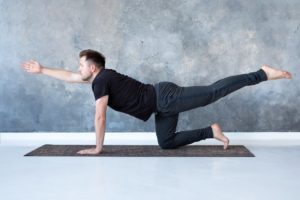 man doing Bird Dog for back pain after a car accident in Dallas