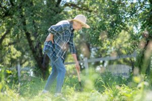 woman with back pain while gardening