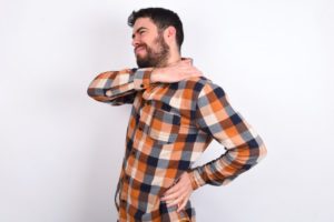 man in plaid shirt with back pain