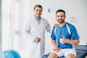 thumbs up chiropractic patient with chiropractor