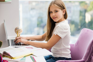 Young teenage girl sitting at a desk